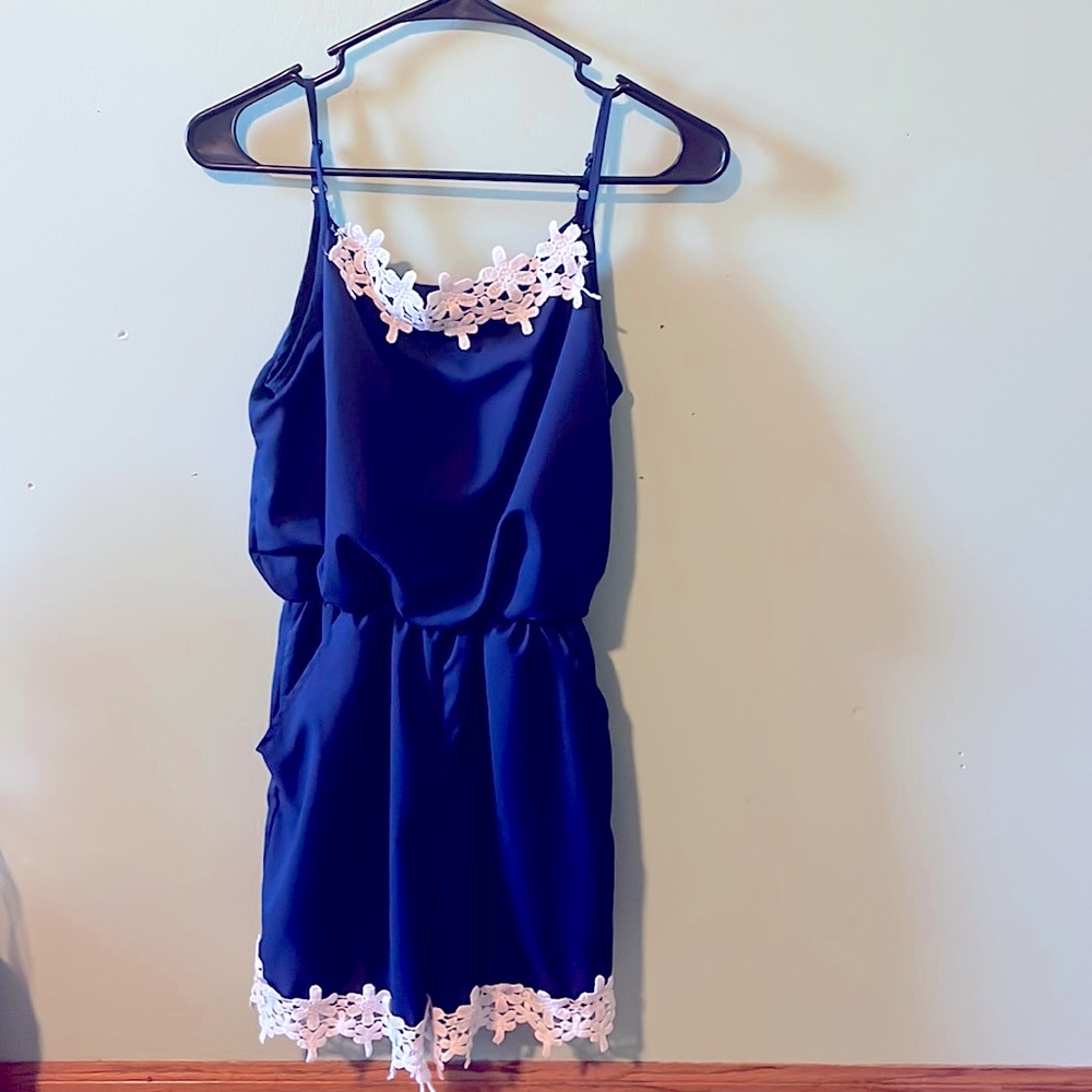 A dark blue jumper with a little bit of white trim on top and around the ends
